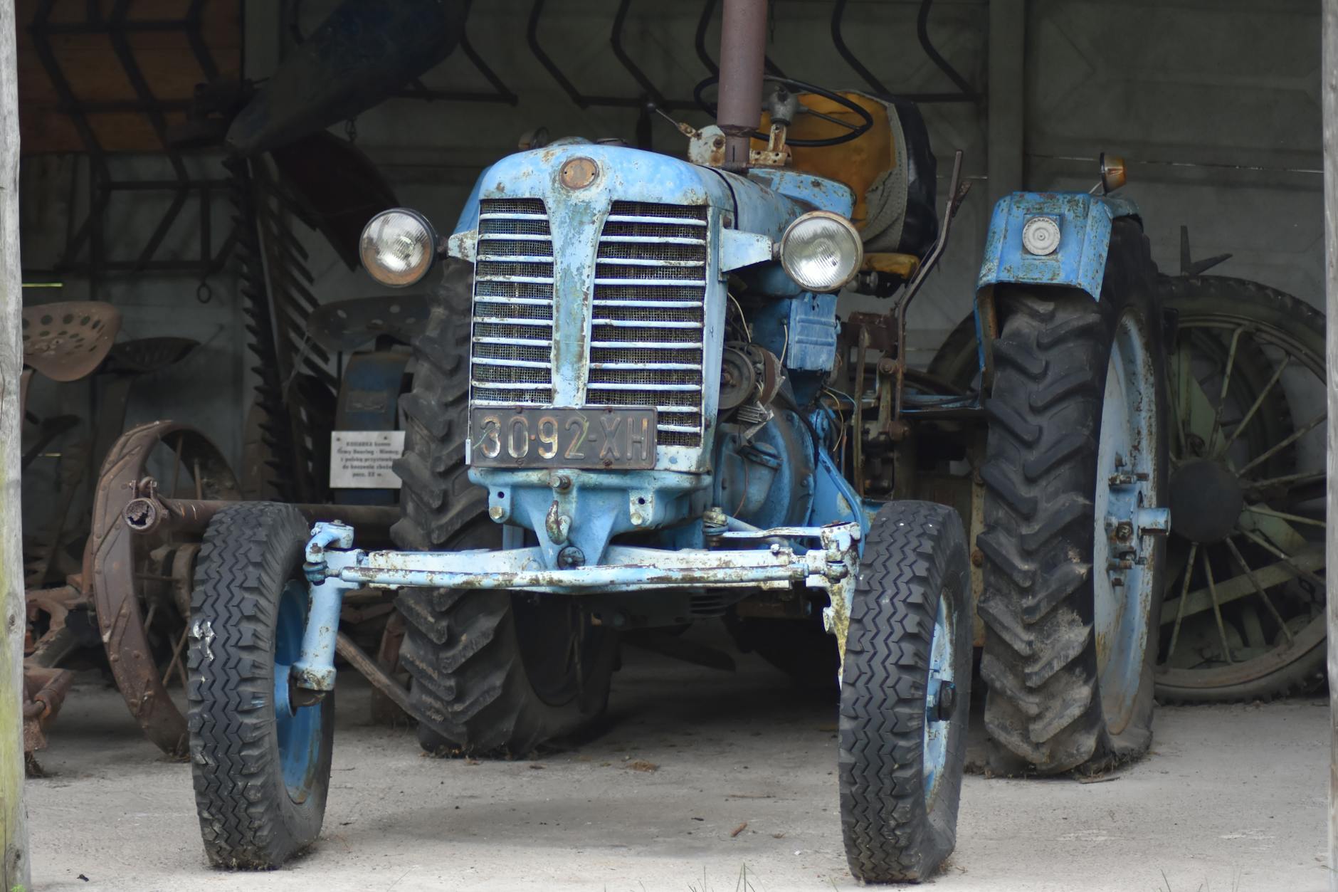 a vintage tractor parked in a garage