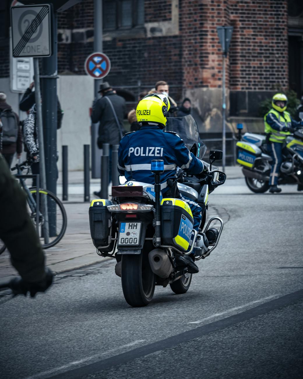 back view of a police officer riding a motorcycle